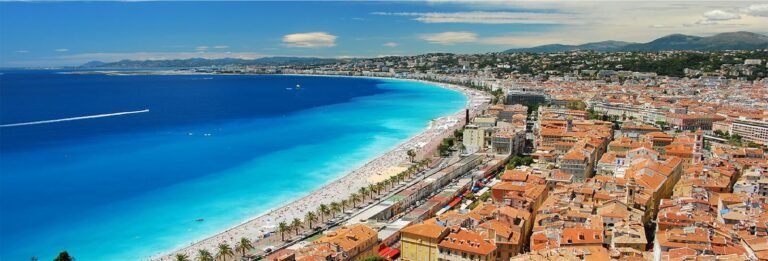 Aerial view of Nice, France with Promenade des Anglais, Mediterranean coastline, and terracotta rooftops